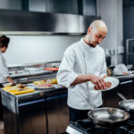 shot two young chefs kitchen